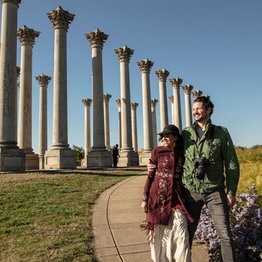 Couple walking by the National Capitol Columns at the National Arboretum - Public park and attraction in Washington, DC Couple walking by the National Capitol Columns at the National Arboretum - Public park and attraction in Washington, DC