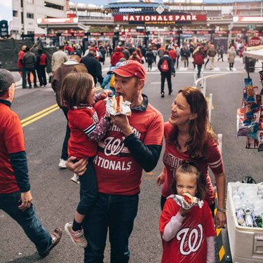 Family eating hot dogs before Washington Nationals baseball game in DC's Capitol Riverfront neighborhood Family eating hot dogs before Washington Nationals baseball game in DC's Capitol Riverfront neighborhood