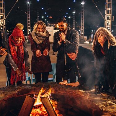 Friends gathered around the fire at The Wharf - Ways to make the most of Winter in Washington, DC Friends gathered around the fire at The Wharf - Ways to make the most of Winter in Washington, DC