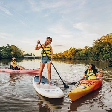 Friends kayaking and paddling on the Anacostia River at sunset - The best things to do this spring and summer in Washington, DC Friends kayaking and paddling on the Anacostia River at sunset - The best things to do this spring and summer in Washington, DC
