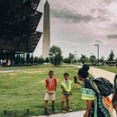 Family taking photo in front of Smithsonian National Museum of African American History and Culture - Guide to DC African American history and culture